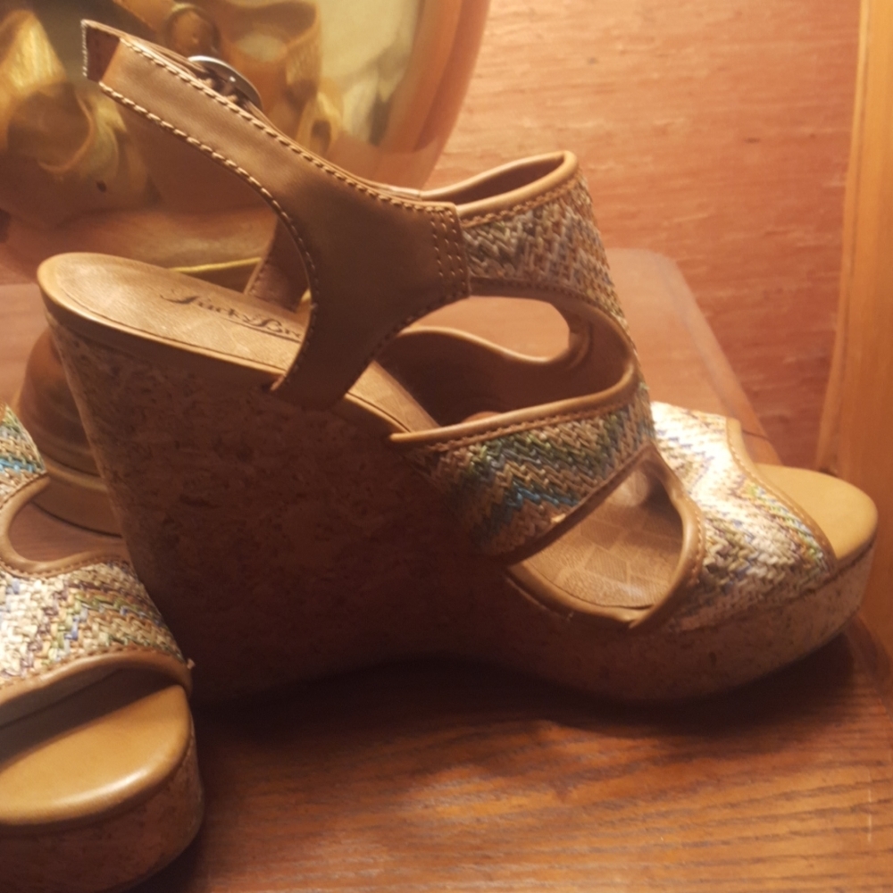 New, never worn. Multi color platform, designer